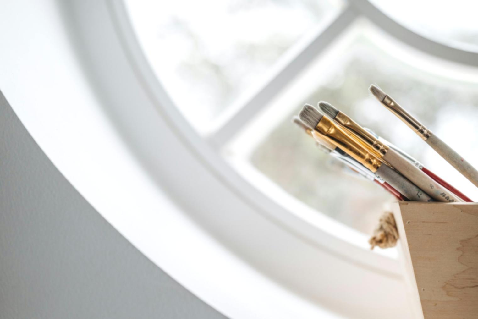 Instructor reviewing student artwork and providing feedback